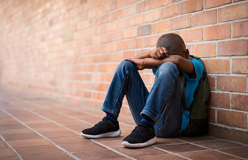 Bully proof your kids boy with head in his hands