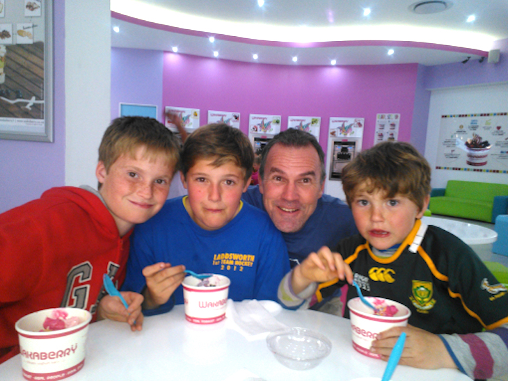 fatherhood dad at table with 3 sons